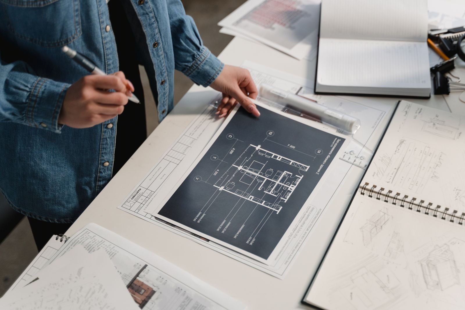 Engineer reviewing architectural blueprints on a desk